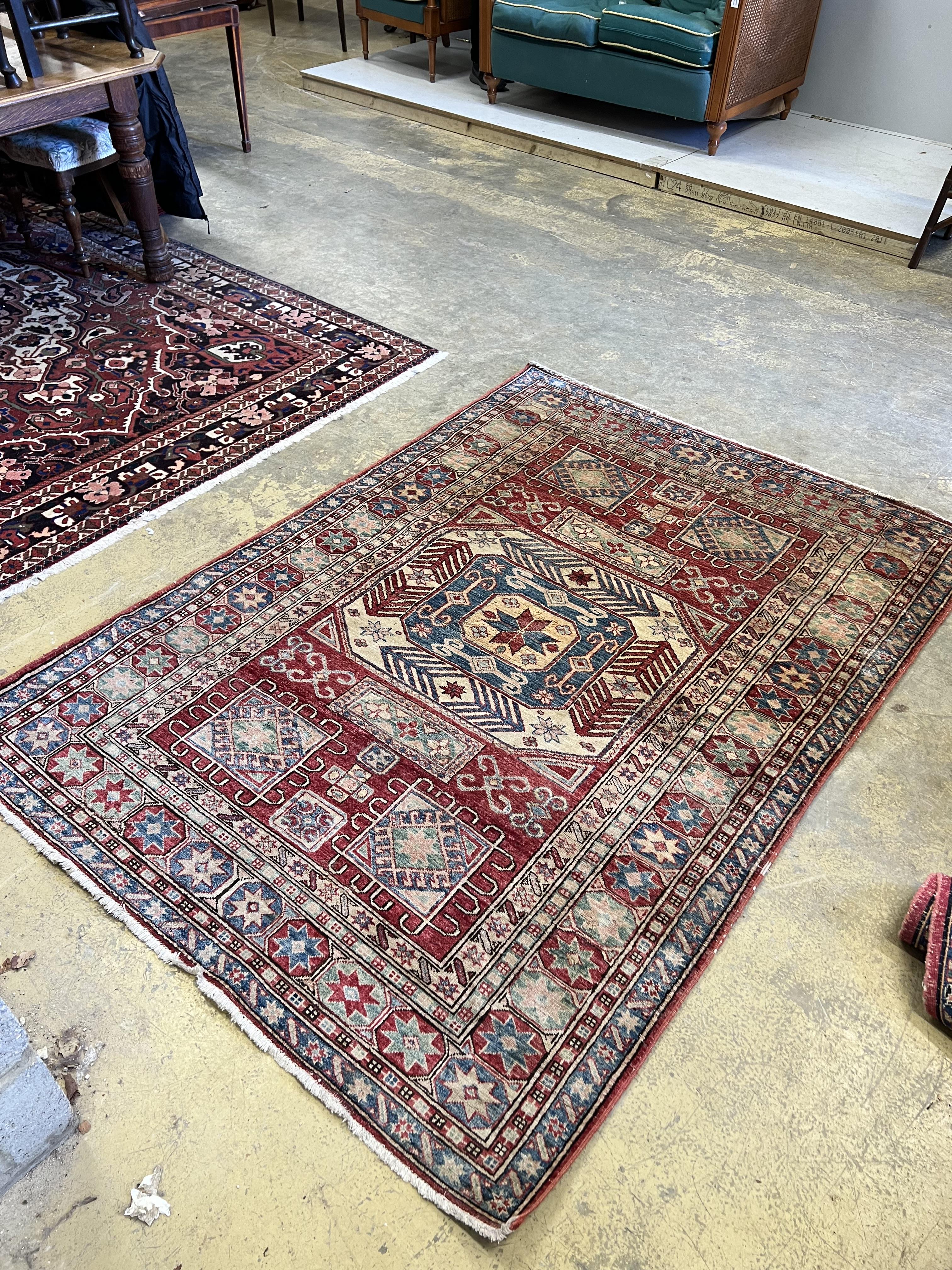 A Caucasian style red ground rug, 207 x 150cm